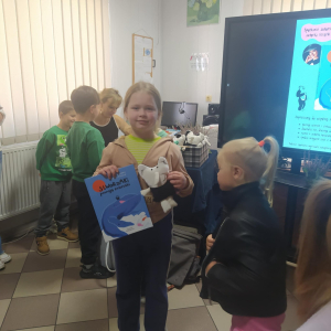 Alicja z książeczką i maskotką.